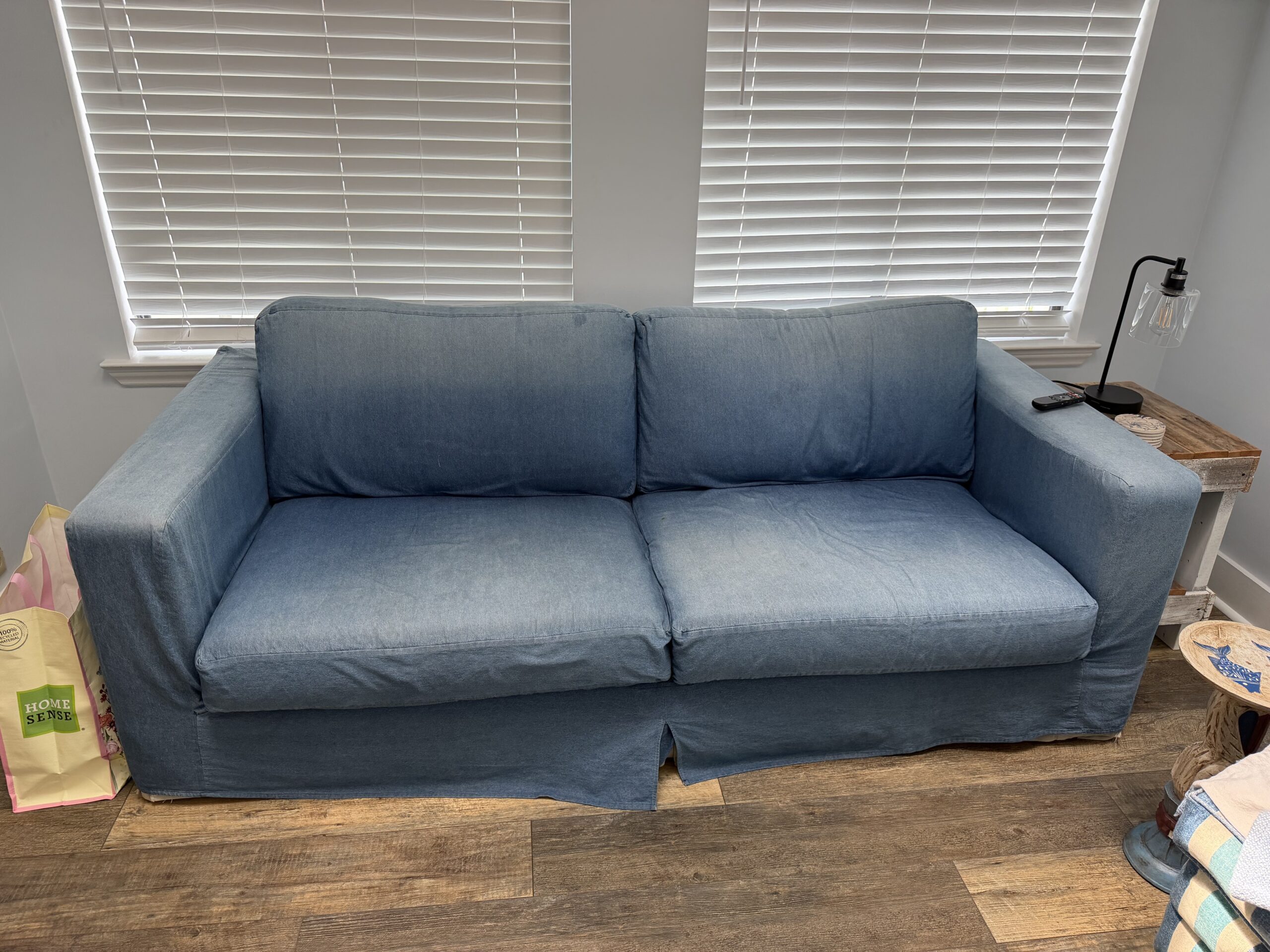 Faded blue denim couch slipcover before dyeing with Rit Denim Blue